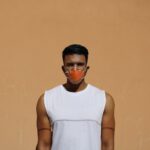 man in white tank top wearing black sunglasses